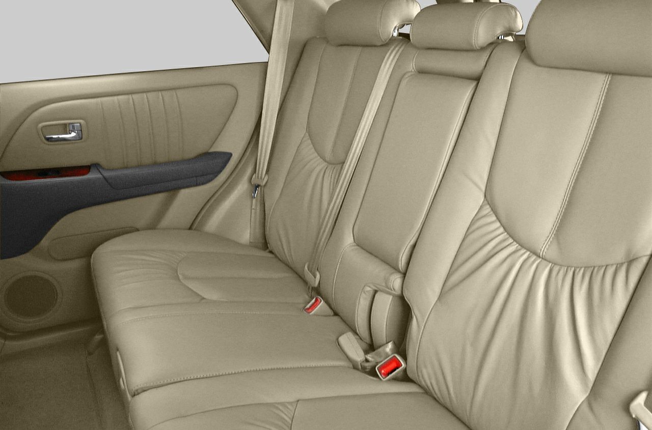 Beige leather rear bench seat with seat belts and door panel