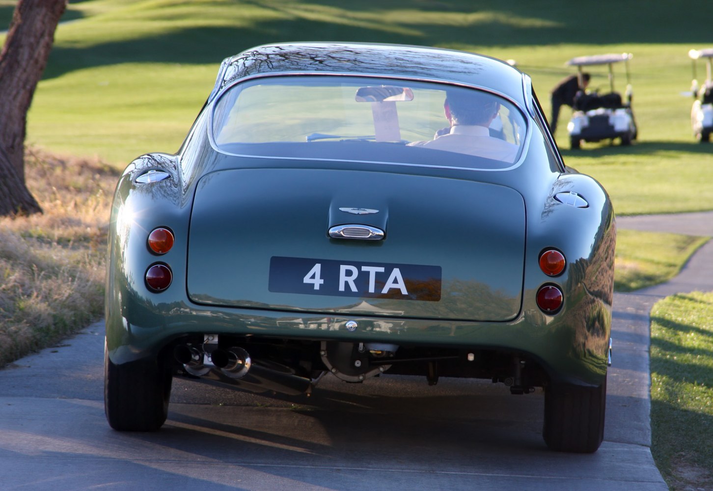 Rear view of vintage coupe with dual exhaust and distinctive round tail lights