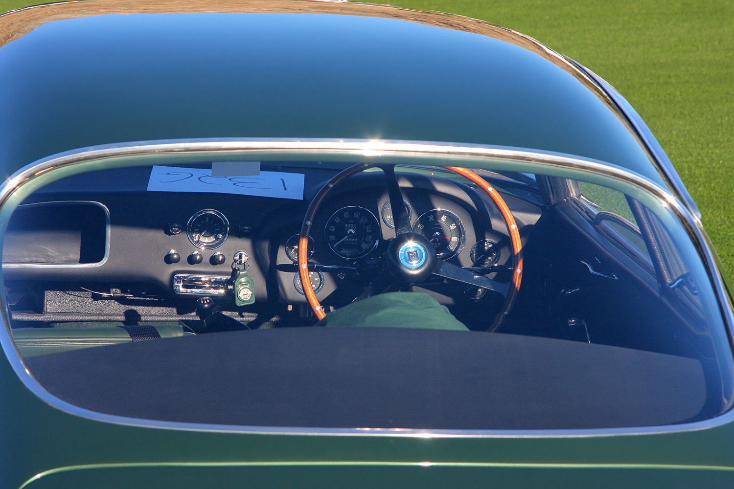 Vintage car interior with wooden steering wheel and analog gauges