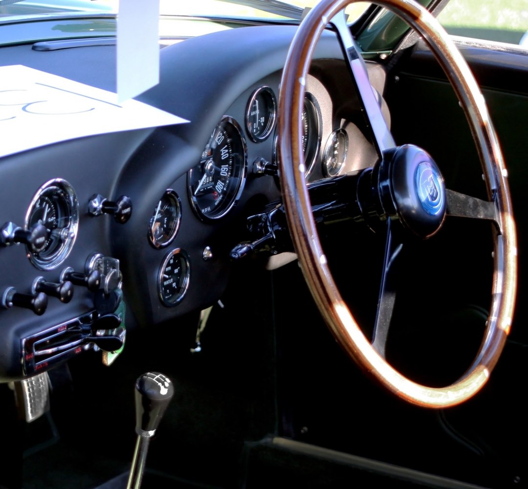 Vintage wooden steering wheel and classic dashboard instruments