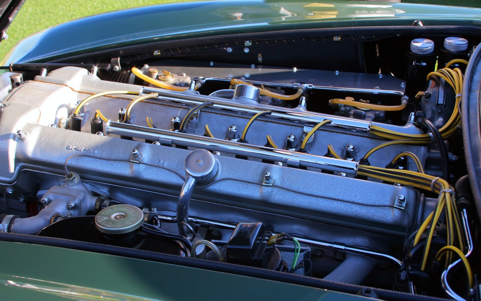Detailed vintage inline-six engine with yellow ignition wires
