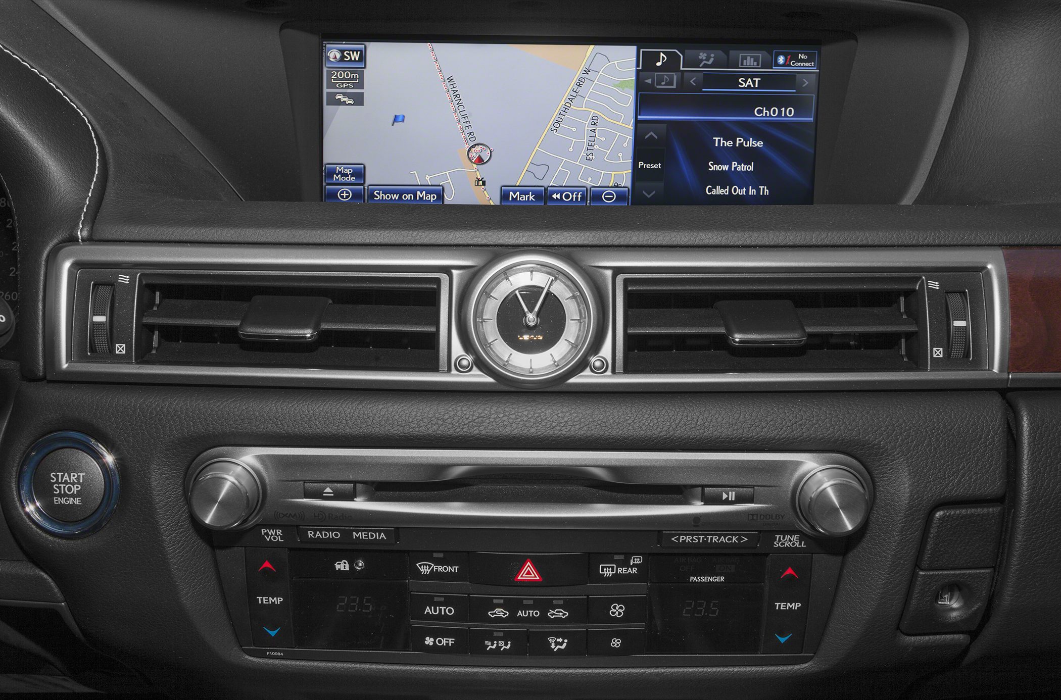 Analog clock, navigation display, start/stop button, climate control panel