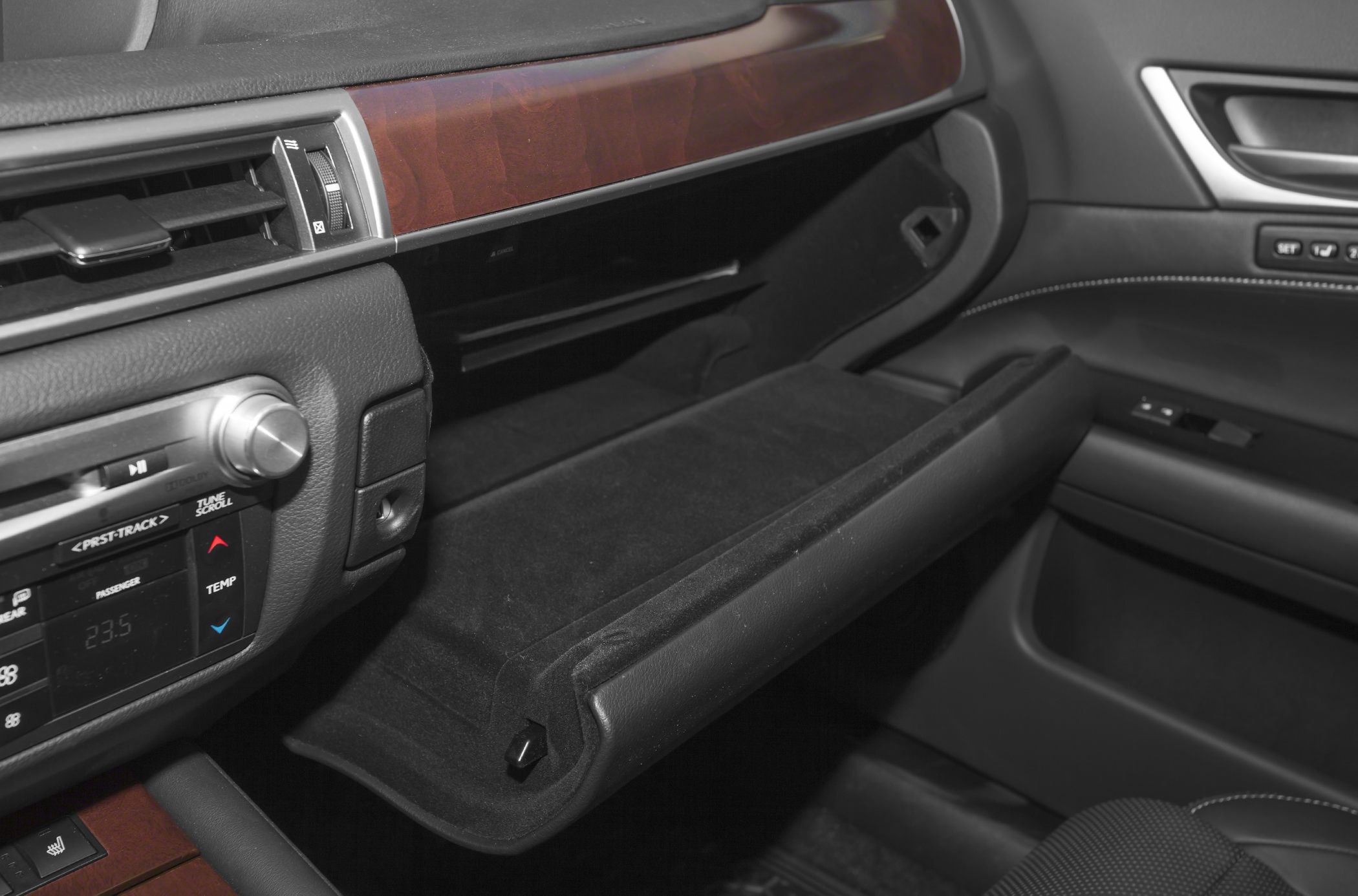 Open glove compartment with wood trim dashboard