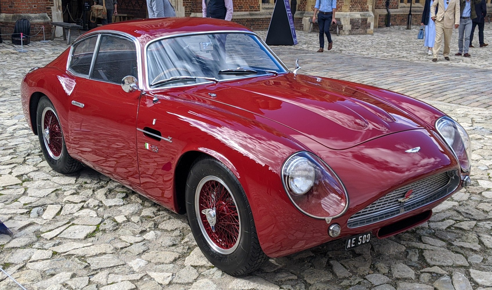 Streamlined racing coupe with rounded headlights and vintage wire-spoke wheels