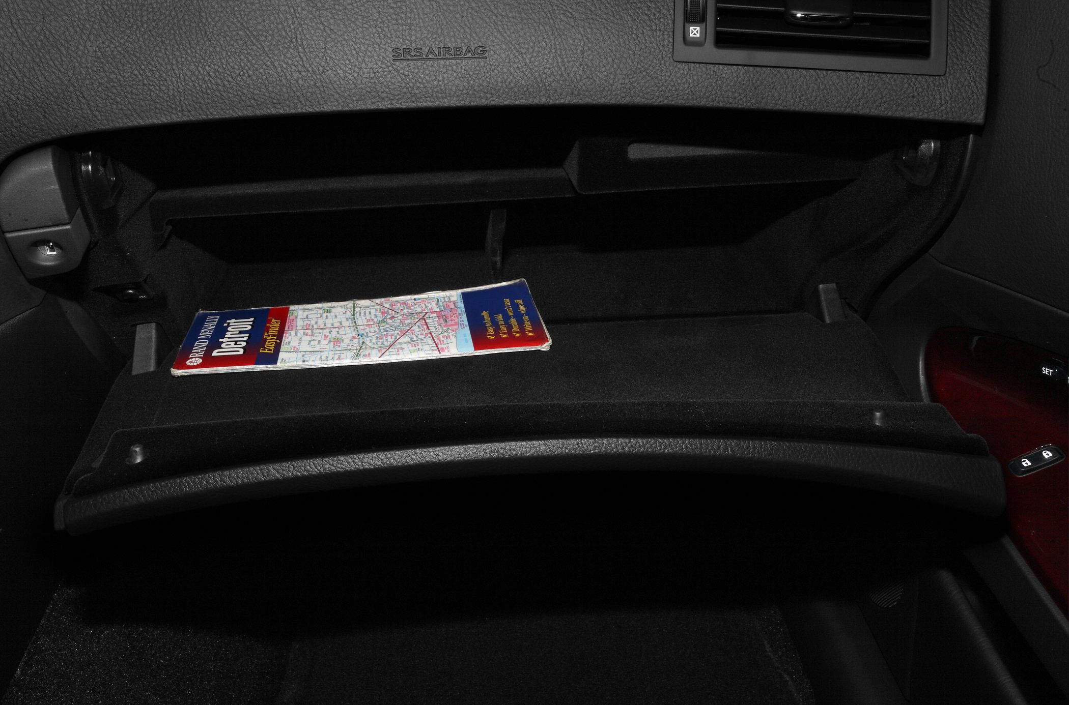 Glove compartment interior with city map inside