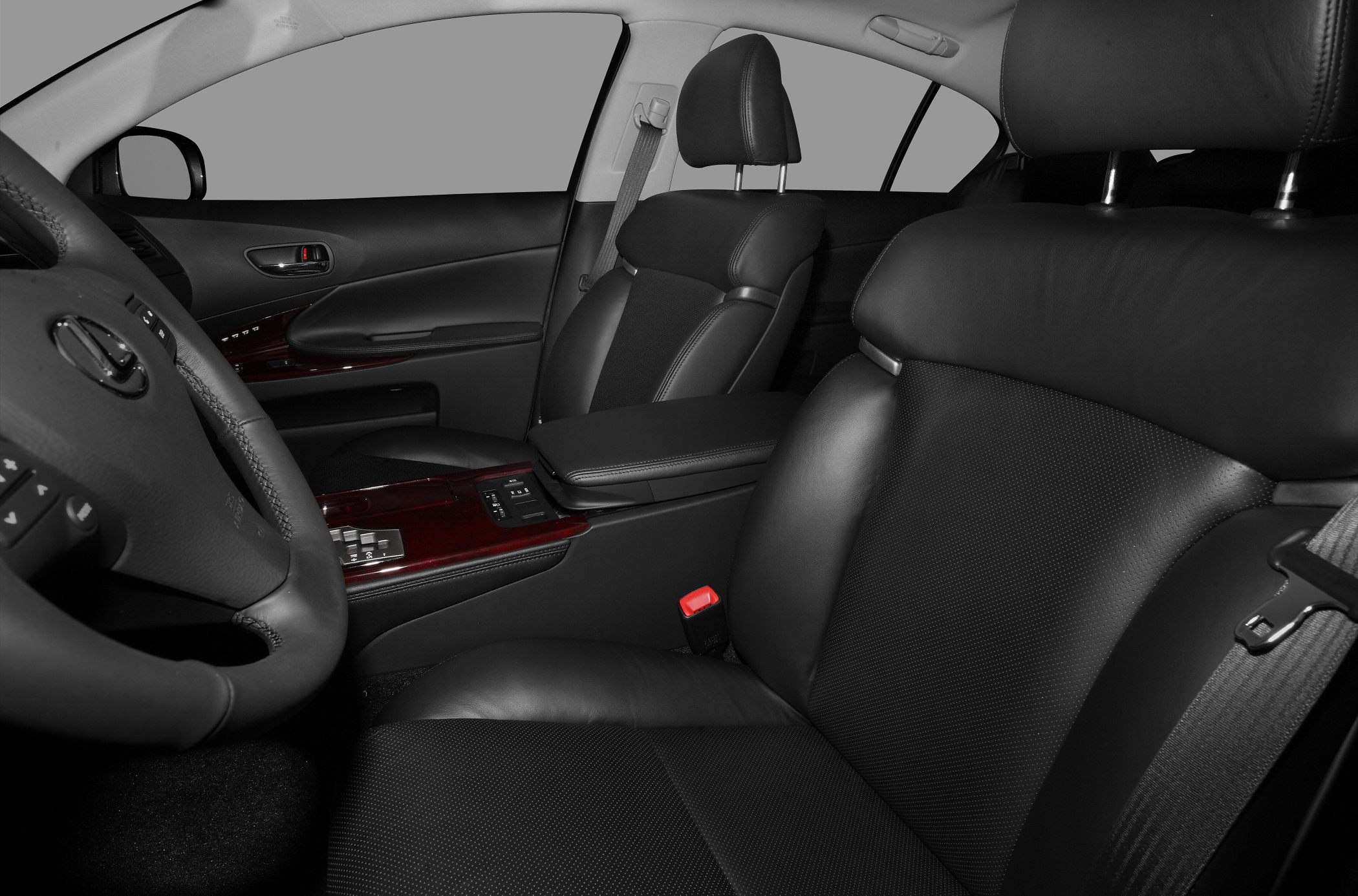 Black leather front seats and dashboard close-up with wood trim