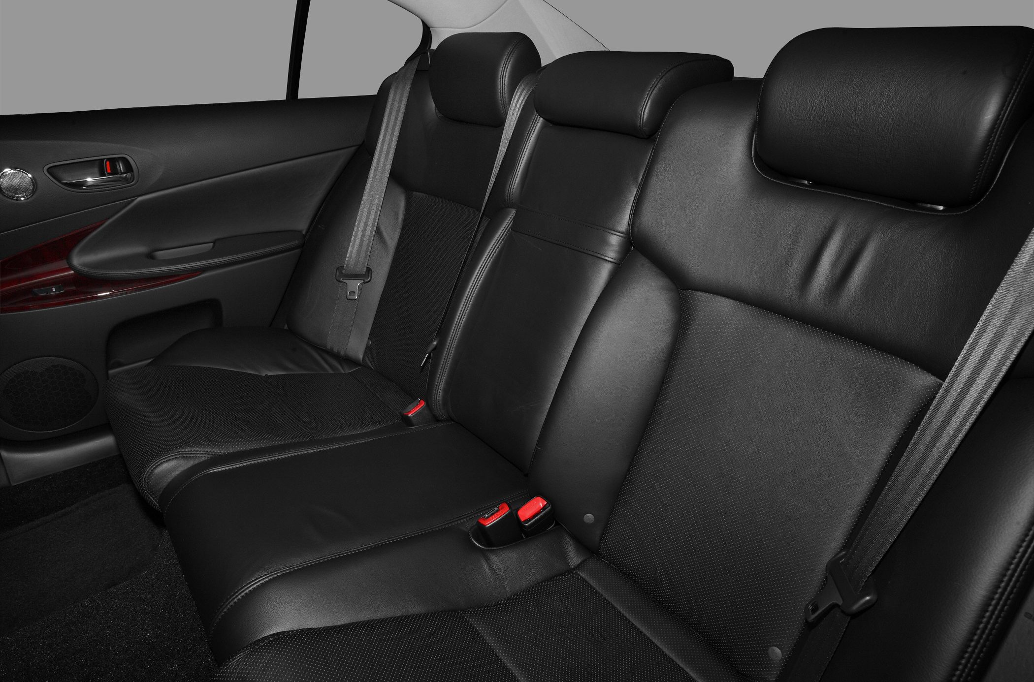 Black leather rear seats with headrests and seatbelts.