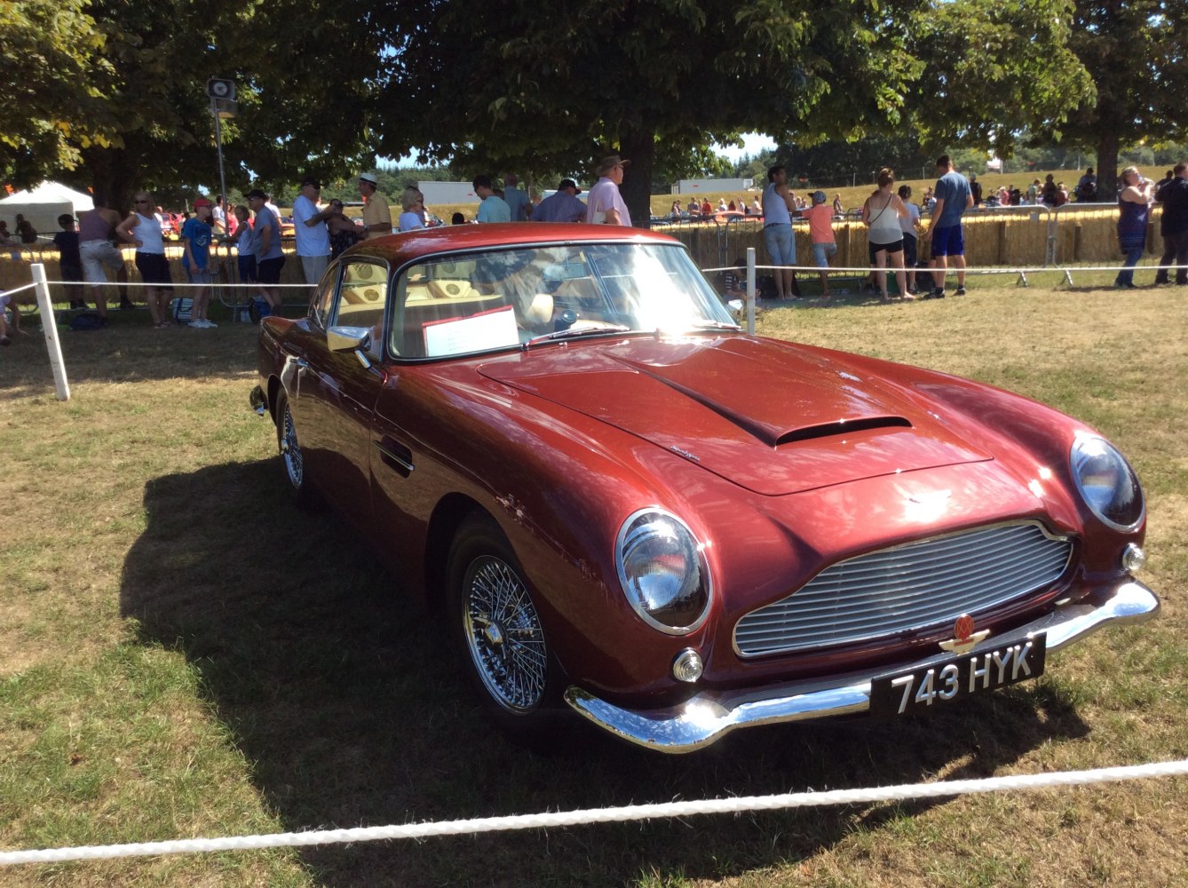 Front view of classic sports car with hood scoop and wire spoke wheels