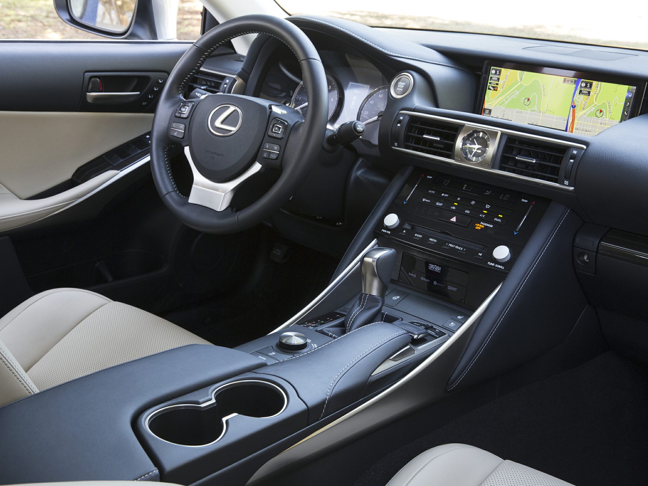 Luxury car interior featuring dashboard, steering wheel, gear shifter, and infotainment display