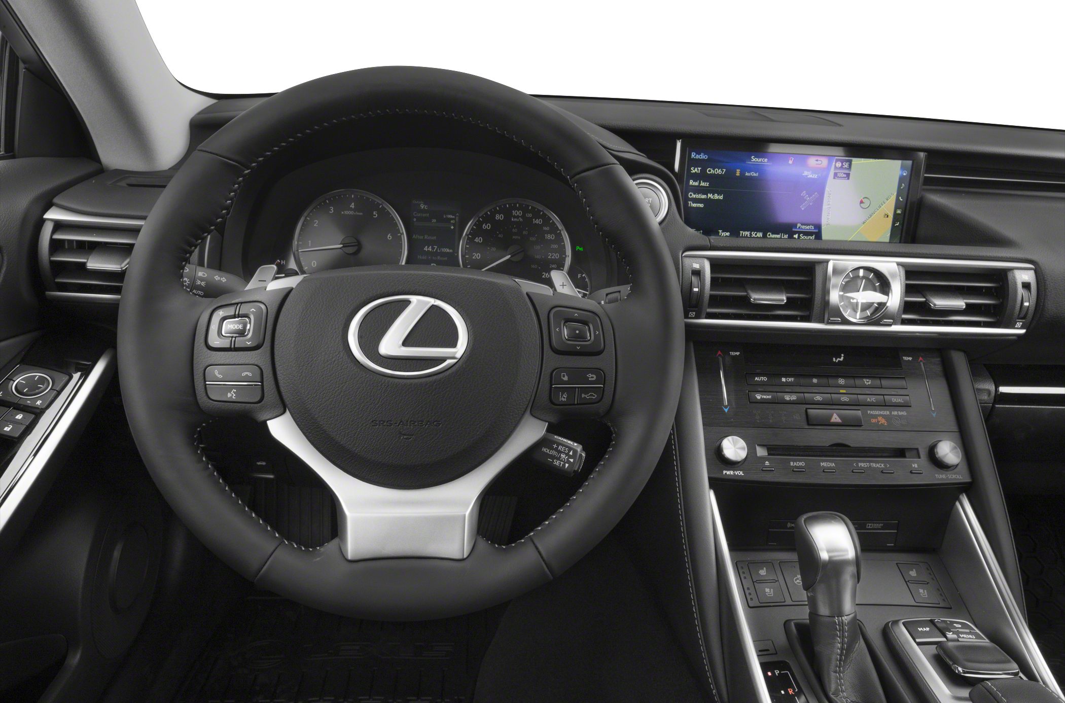 Steering wheel with control buttons, analog clock, infotainment display