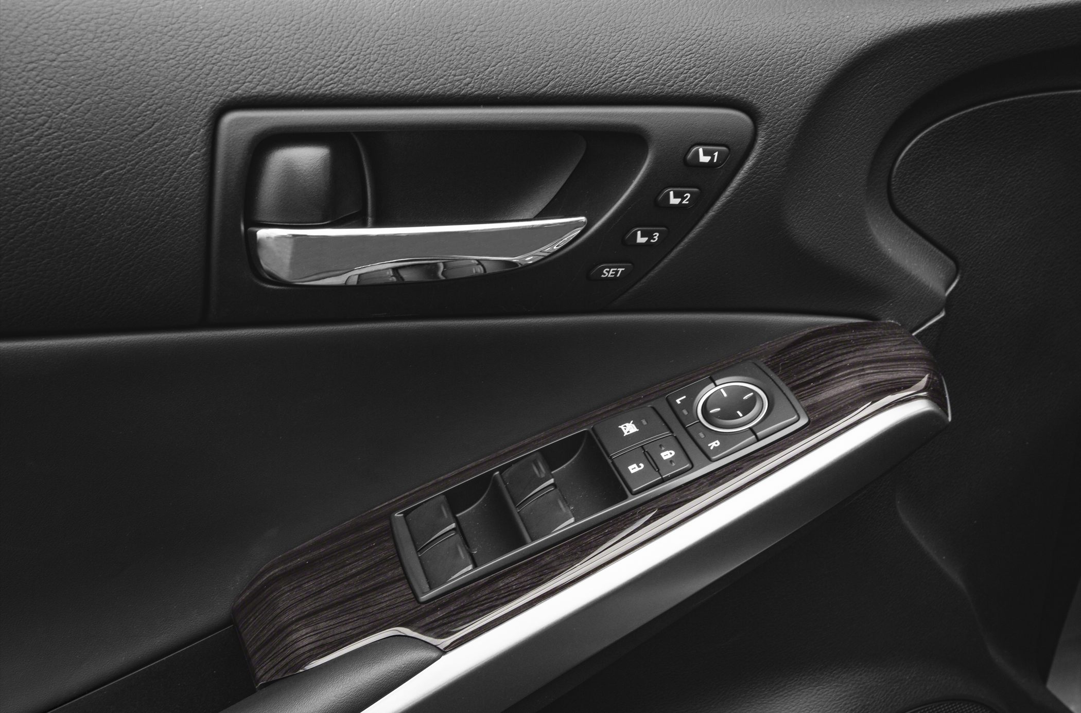Door panel with window controls, seat memory, and mirror adjustment.