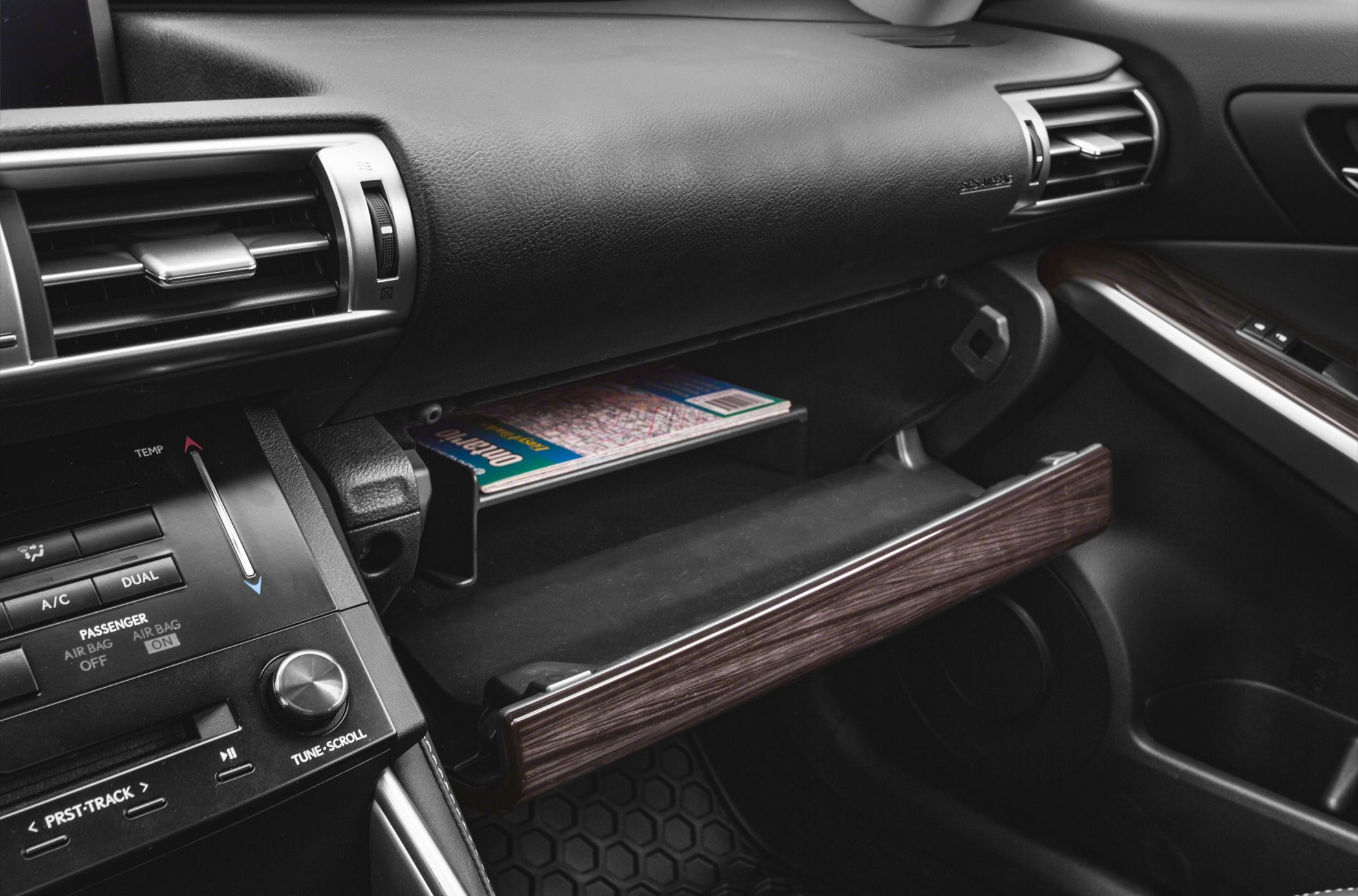 Open glovebox with map, dashboard air vent and climate control panel
