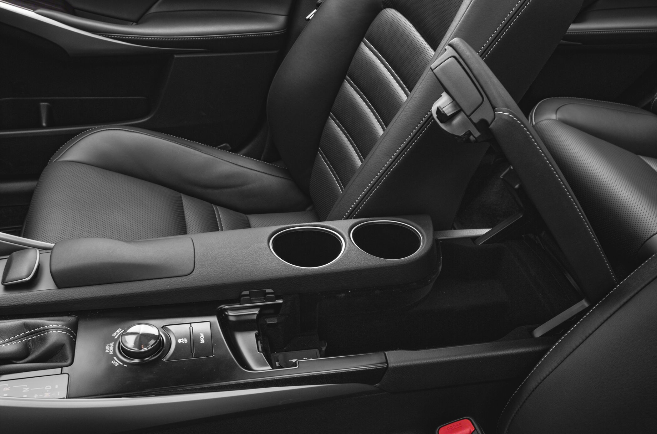 Leather seats and center console with controls and cupholders.