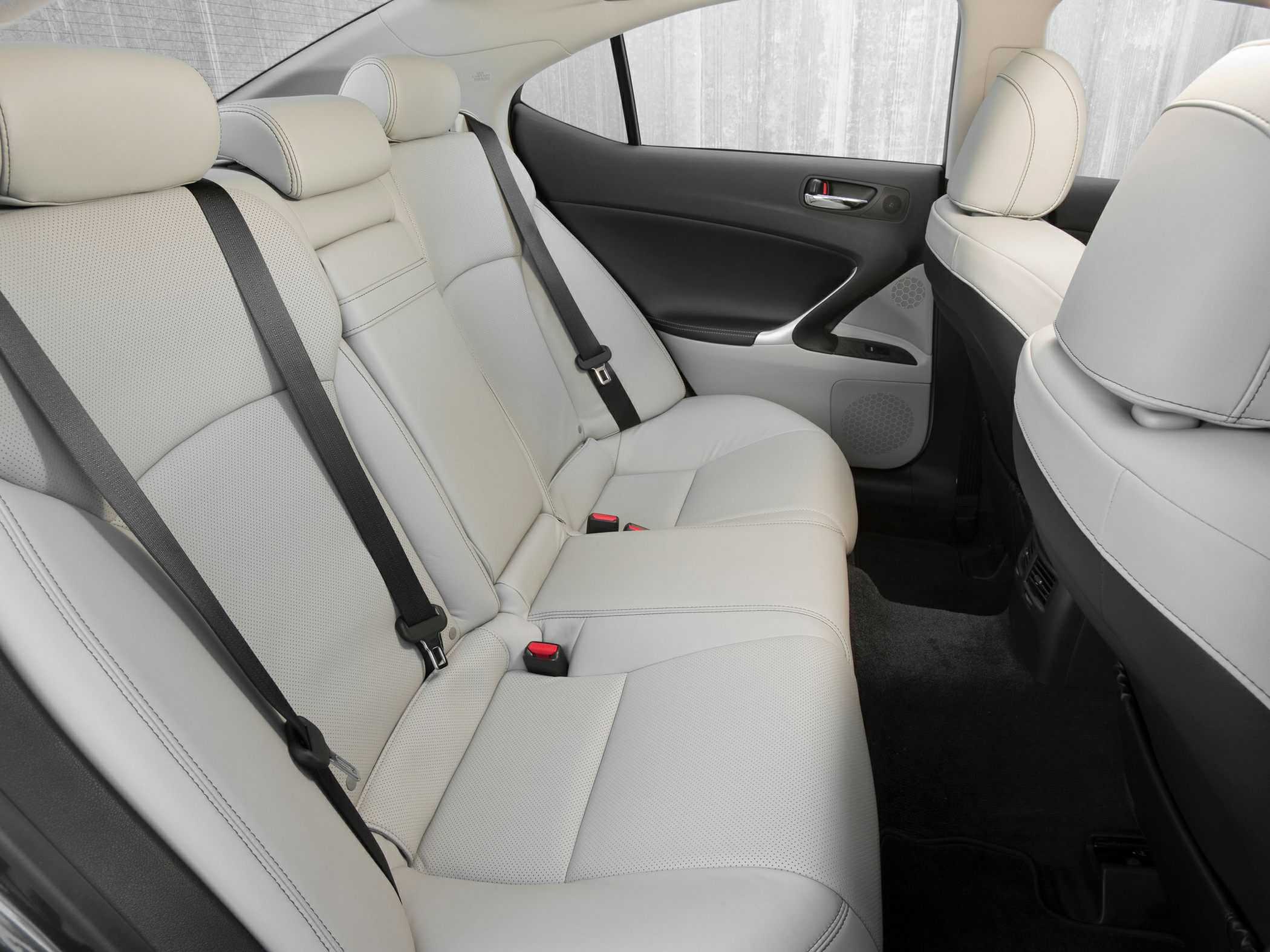 Spacious rear perforated leather seats with seat belts and modern door panel