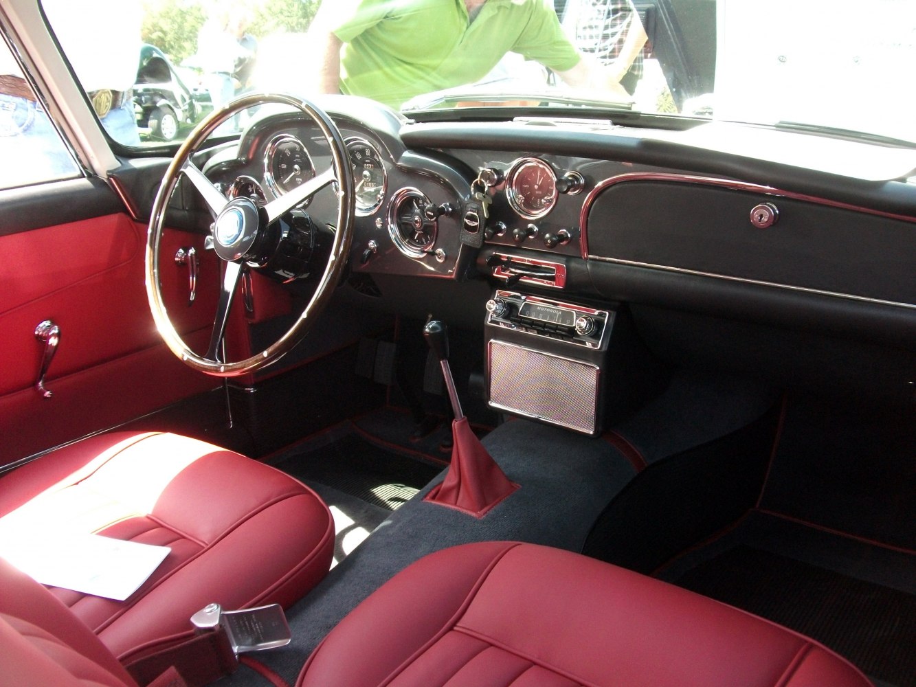 Vintage red leather interior with classic dashboard and manual gear shift