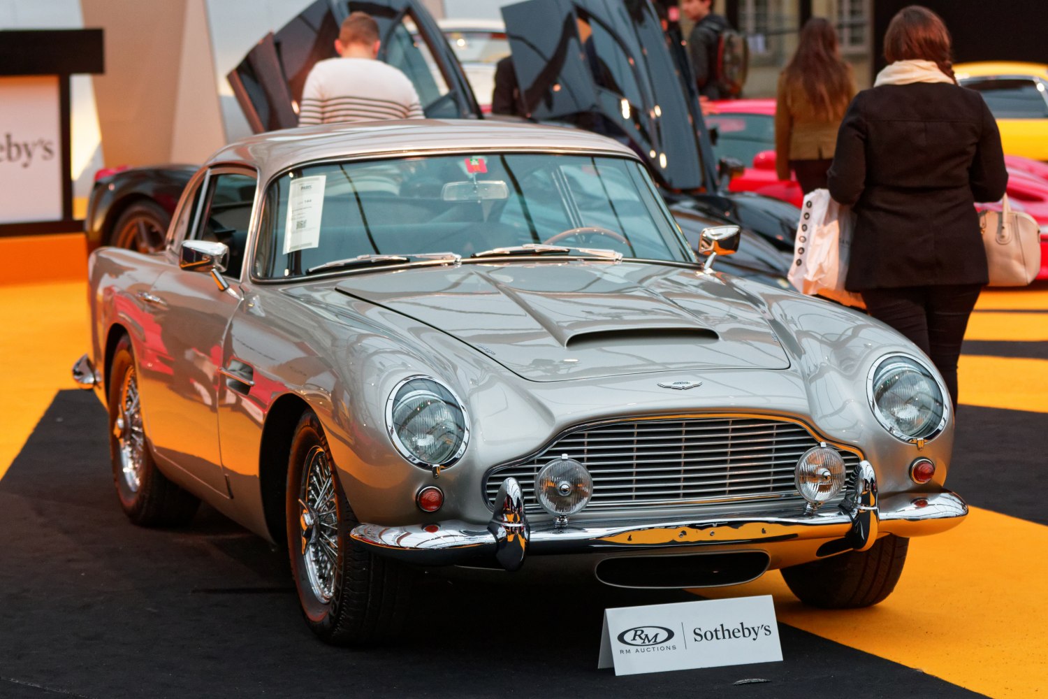 Classic 1960s sports car front with chrome grille and round headlights