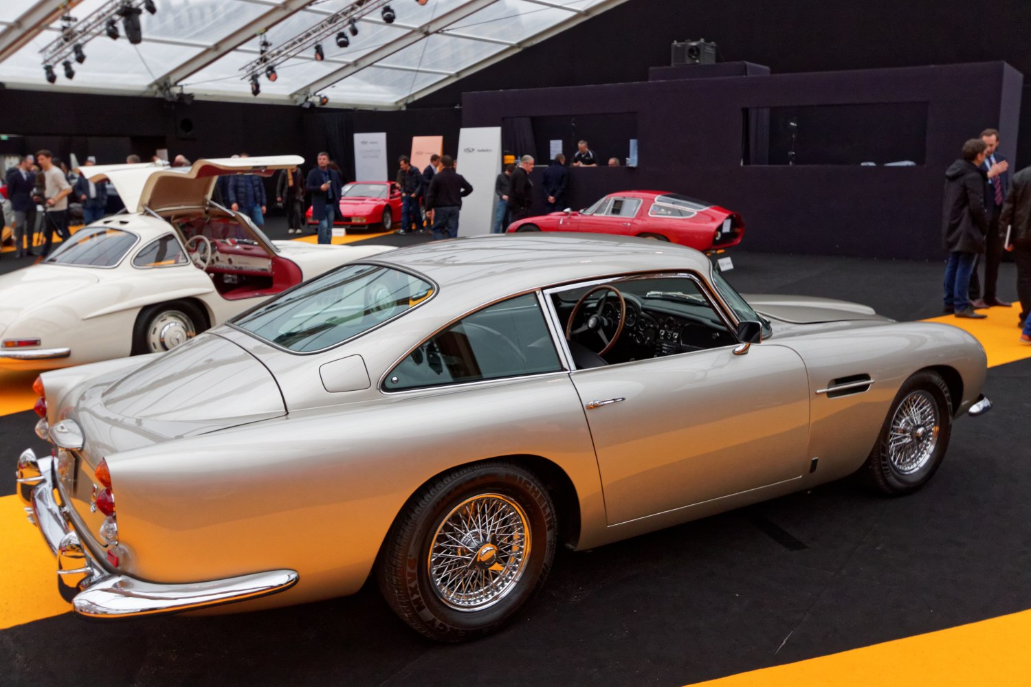 Sleek silver vintage coupe with wire-spoke wheels and classic styling