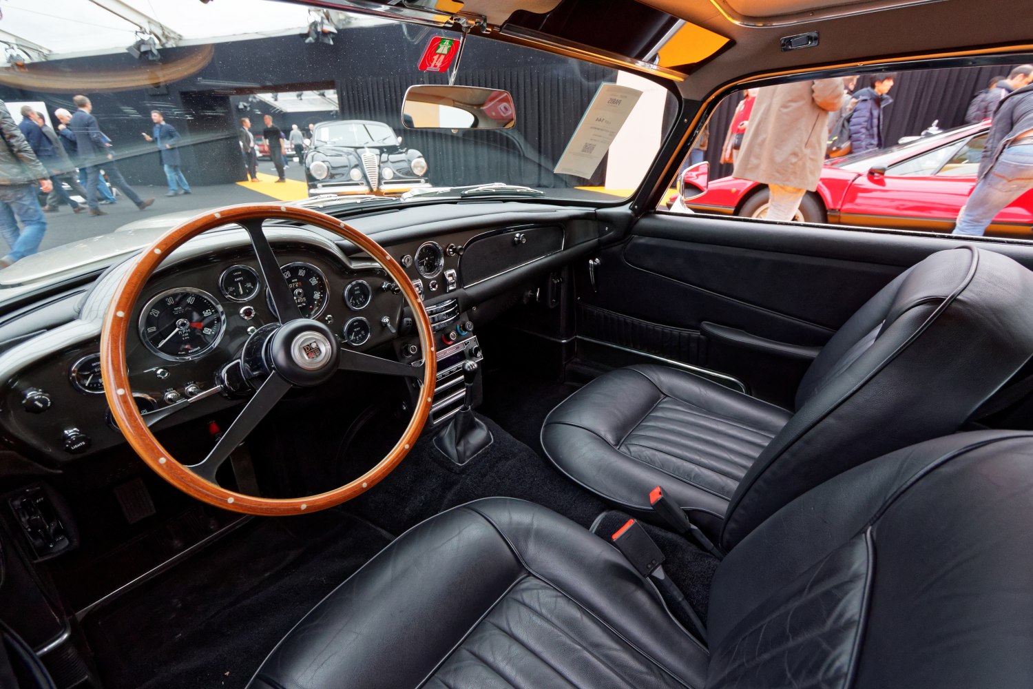 Black leather seats and wooden steering wheel with classic dials