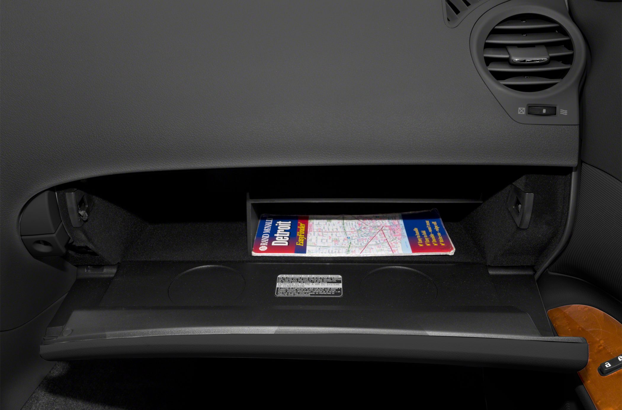 Open glove compartment with map inside a car's interior