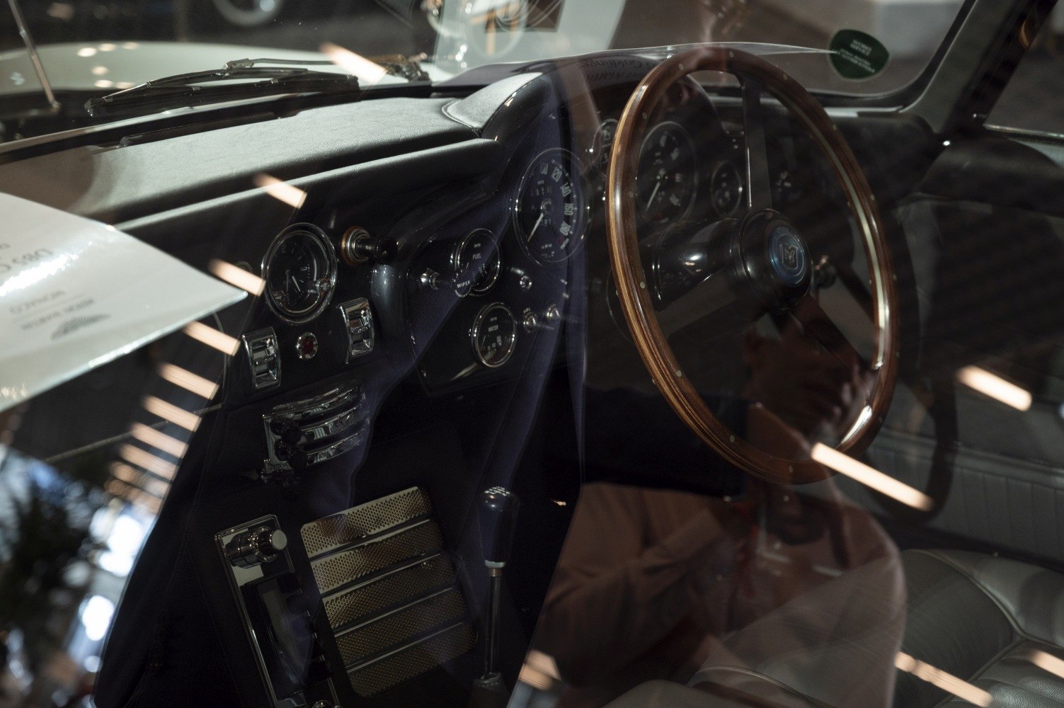 Wooden steering wheel and classic vintage dashboard with analog gauges