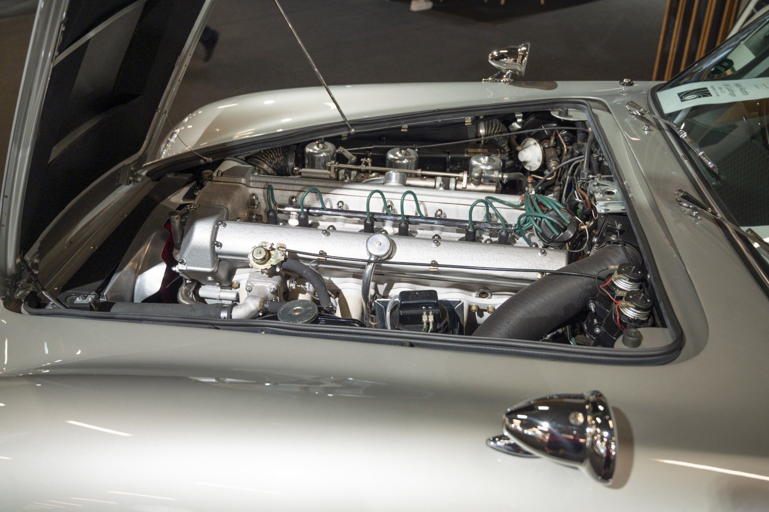 Classic V12 engine with detailed components in open hood view