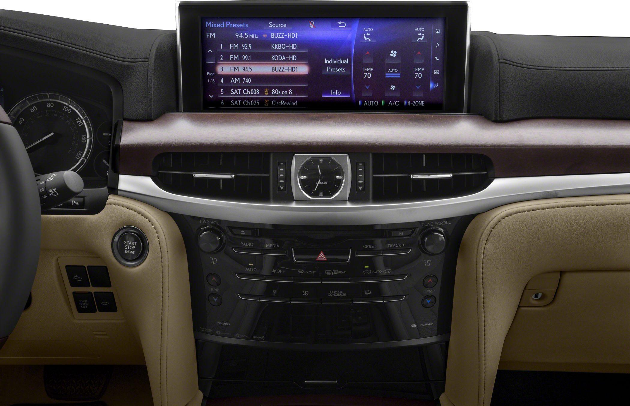 Luxury vehicle dashboard with infotainment and analog clock