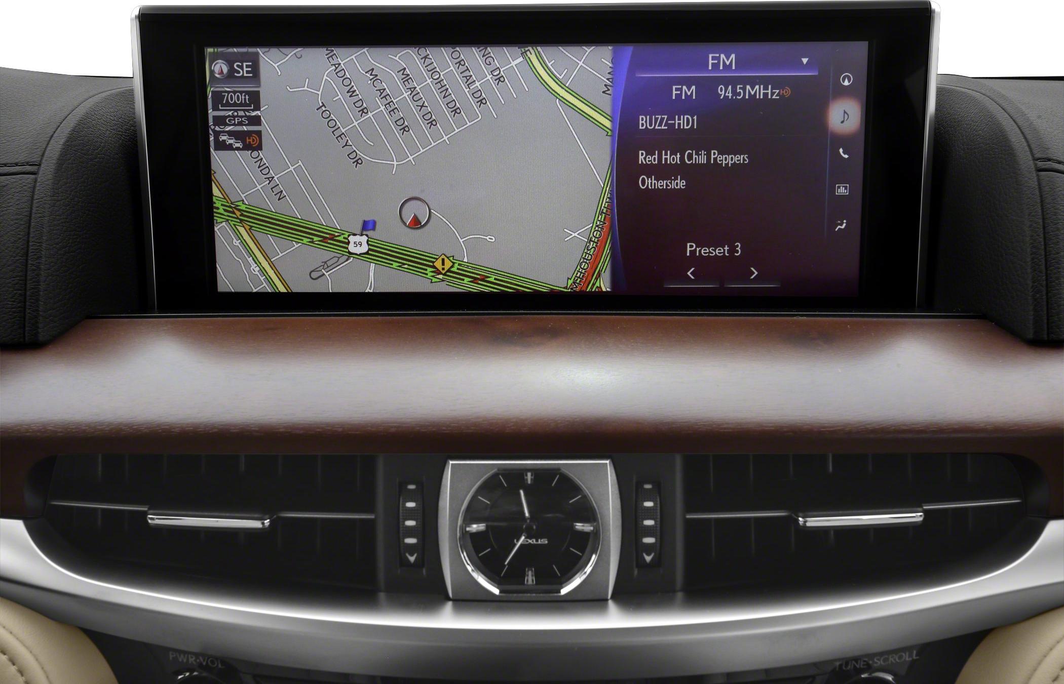 Touchscreen navigation and FM radio interface with analog clock on dashboard