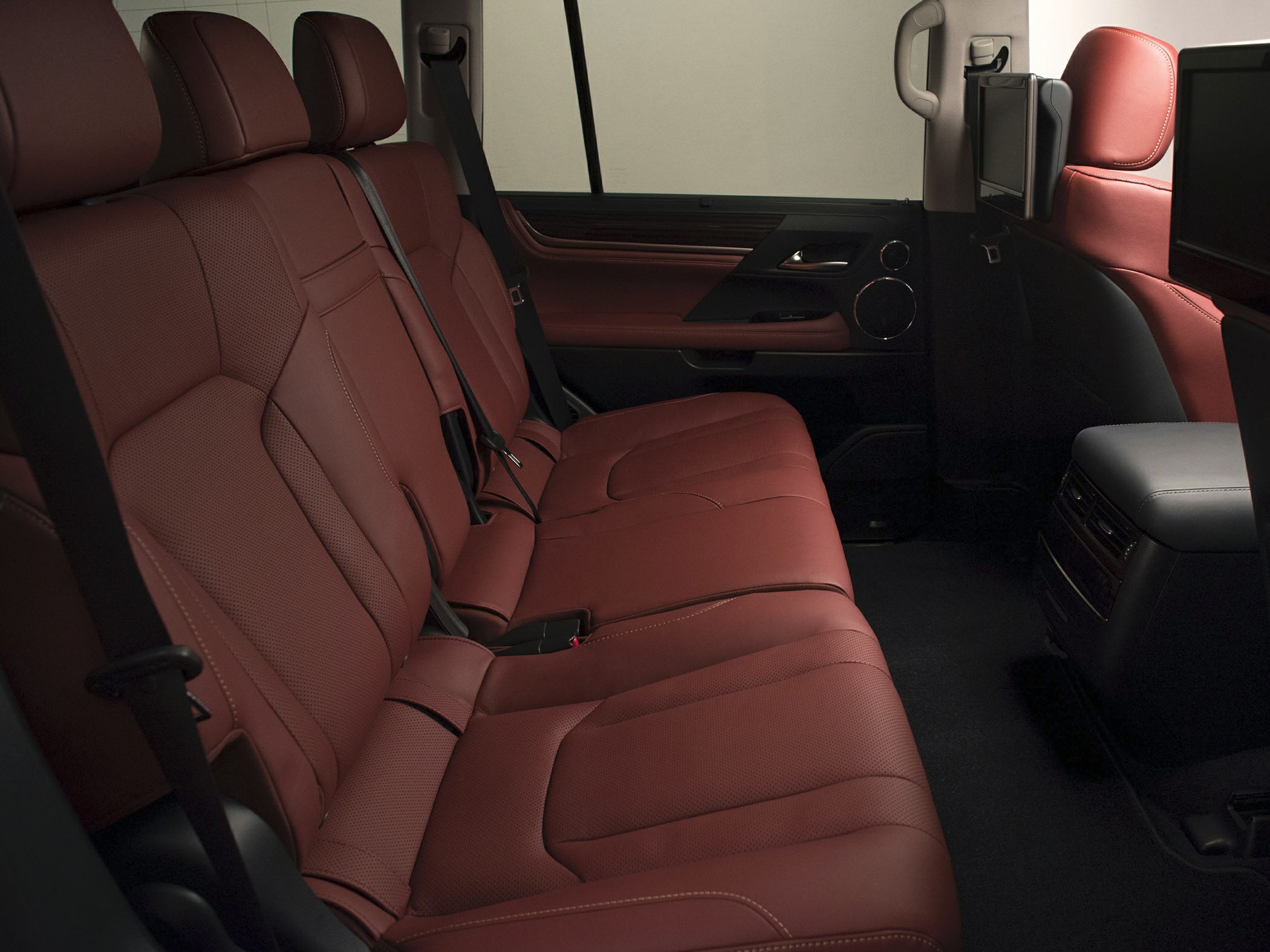 Rear passenger seats with leather upholstery and entertainment screens