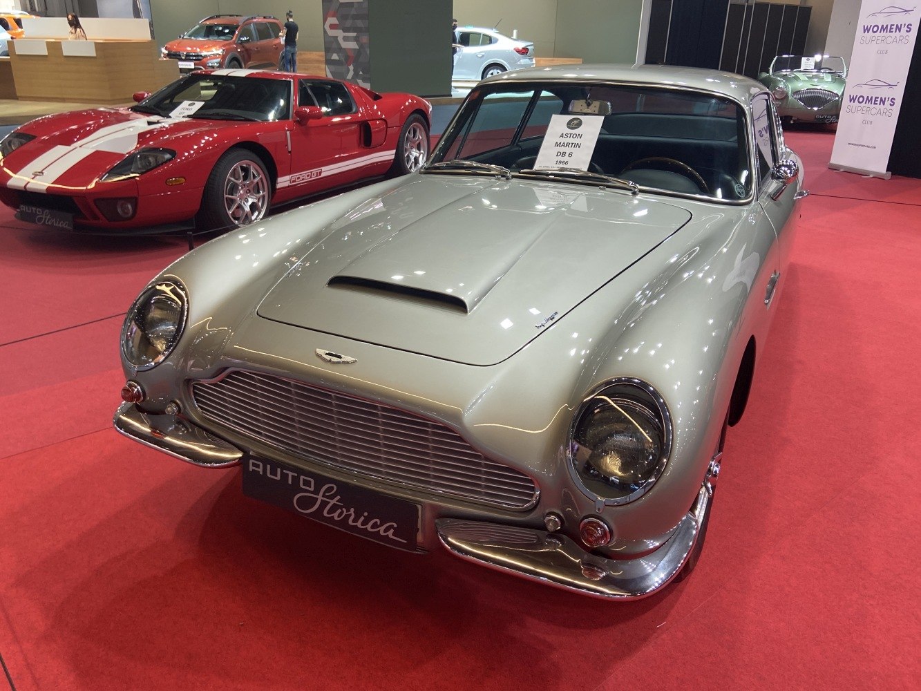 Classic car front grille, hood scoop, and elegant curved body design.