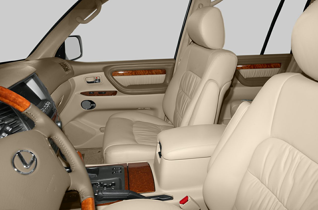 Beige leather seats and polished wood trim interior of a luxury SUV