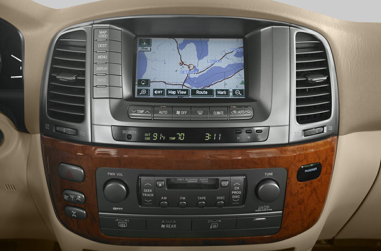 Navigation screen with climate control and audio system in wood-trimmed dashboard