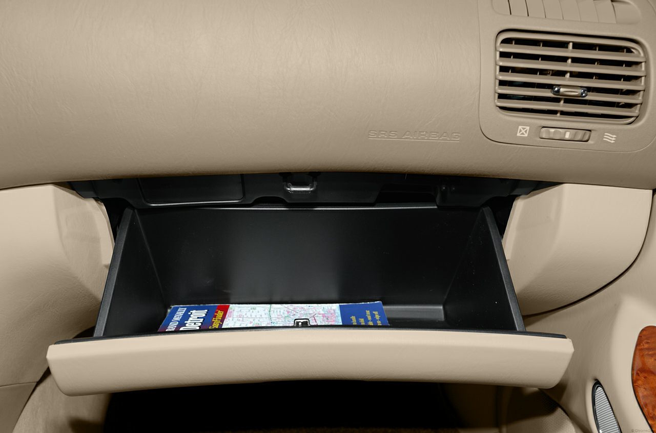 Open glove box with storage and nearby dashboard air vent