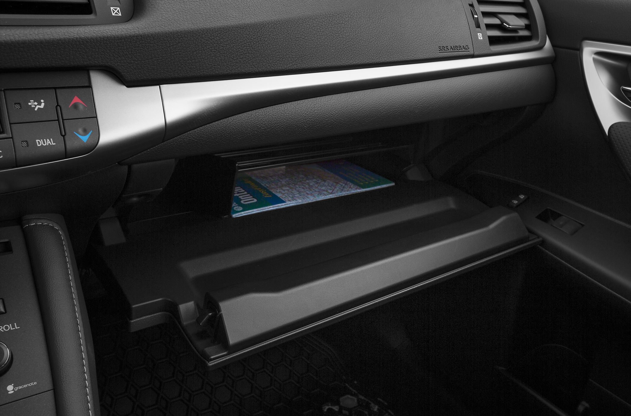 Glove box with map inside and adjacent dashboard climate control buttons