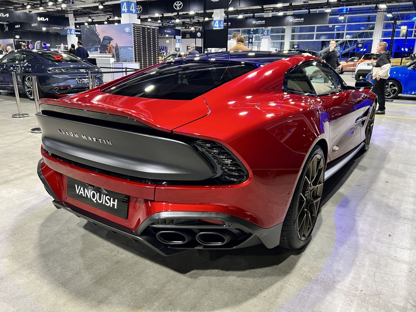 Sleek rear design with quad exhaust and carbon fiber accents on a red sports coupe