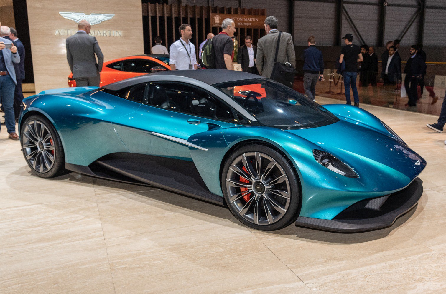 Futuristic aerodynamic sports car with detailed alloy wheels in blue.