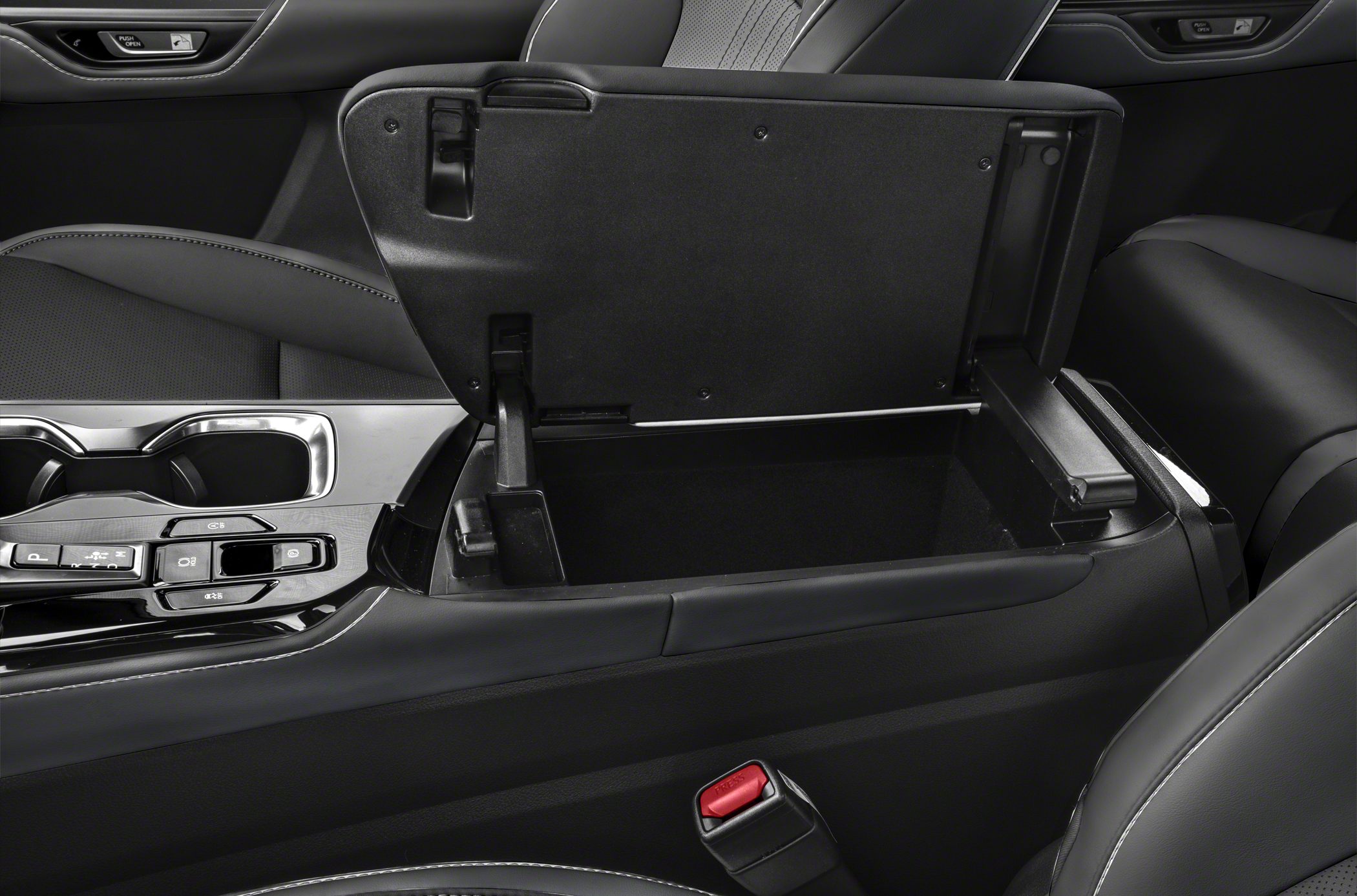Open center console storage compartment with modern interior design.