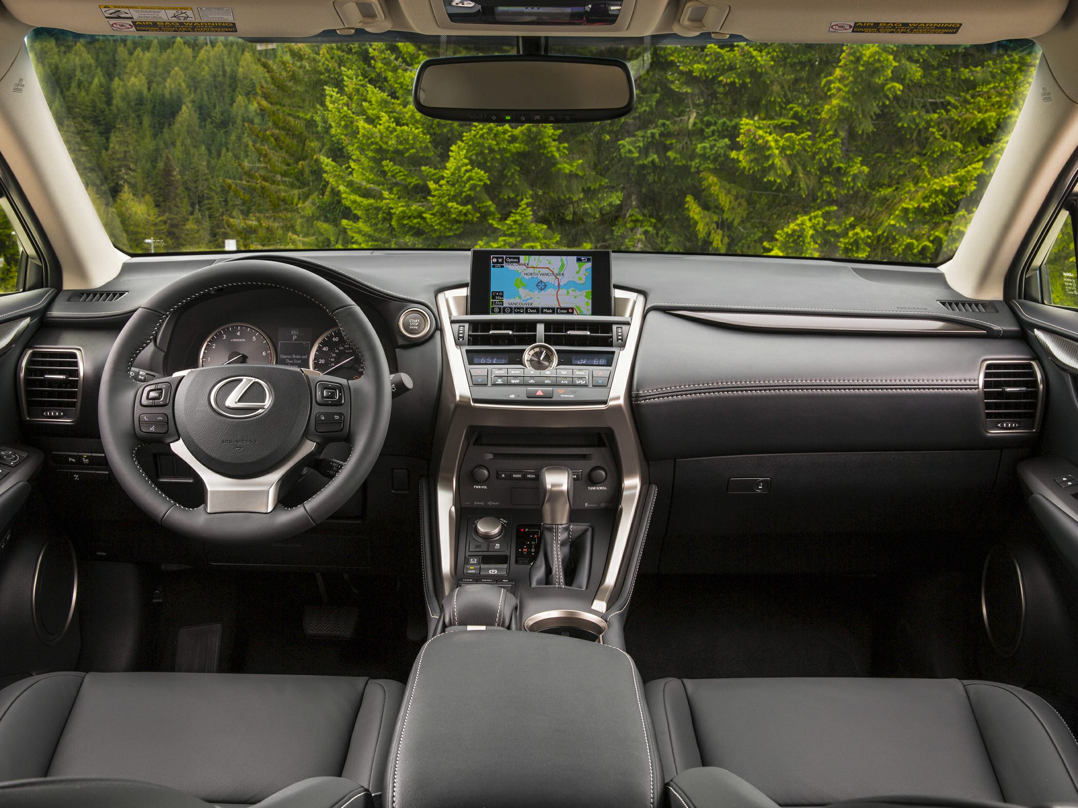 Leather steering wheel, digital navigation screen, and center console with controls
