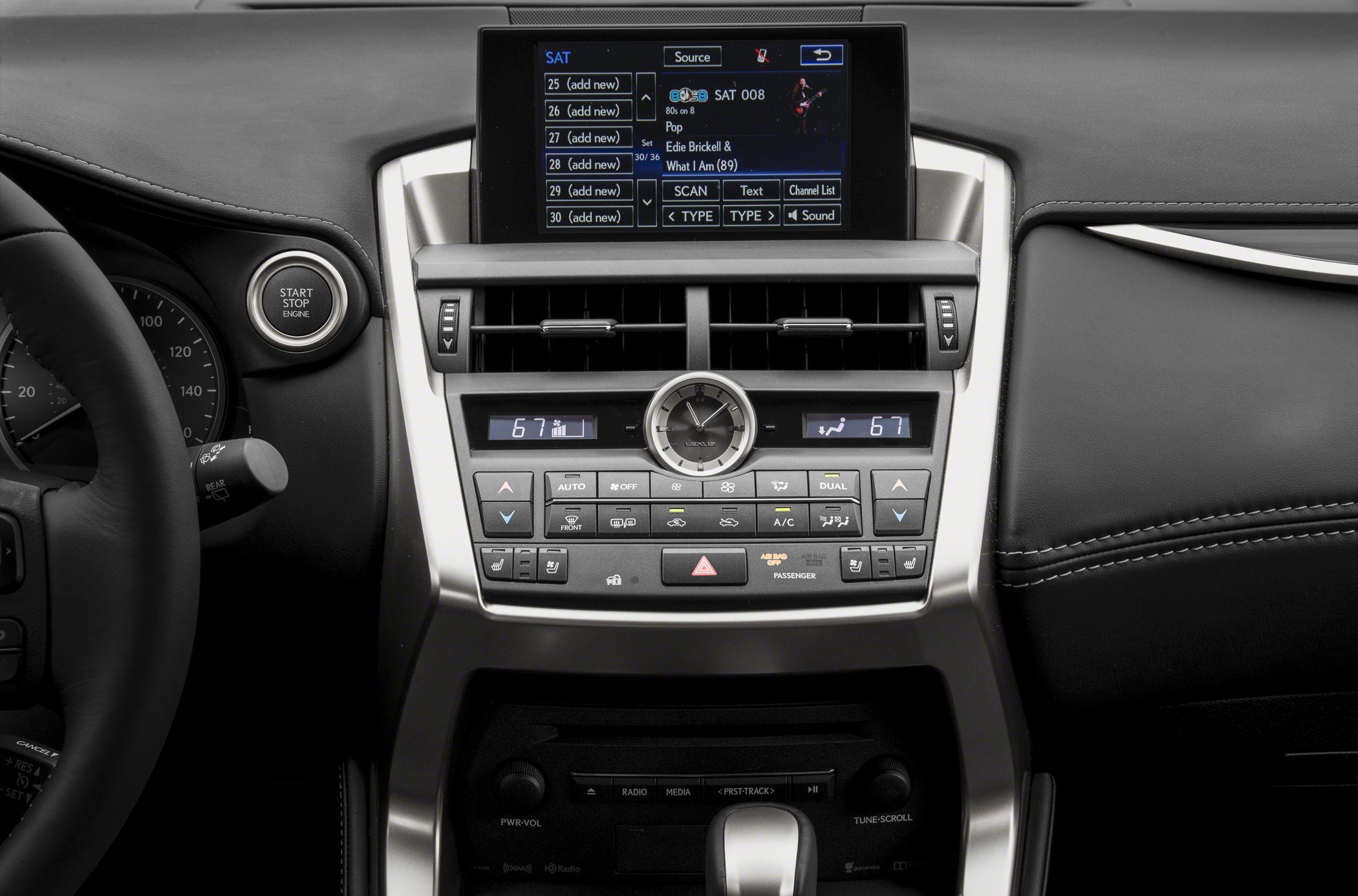 Car dashboard with digital climate control, analog clock, and infotainment display
