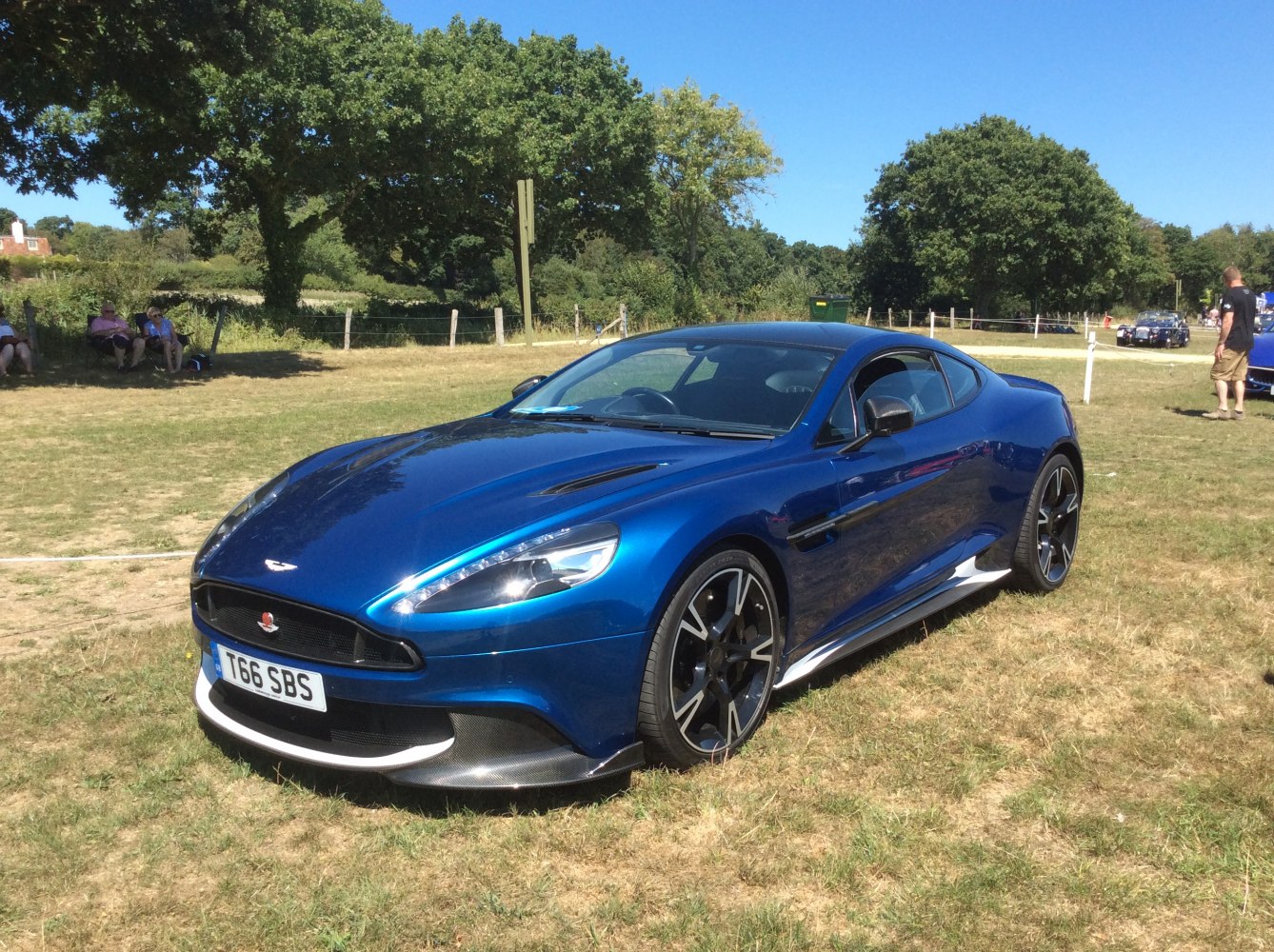 Front-side view of a blue sports coupe with alloy wheels