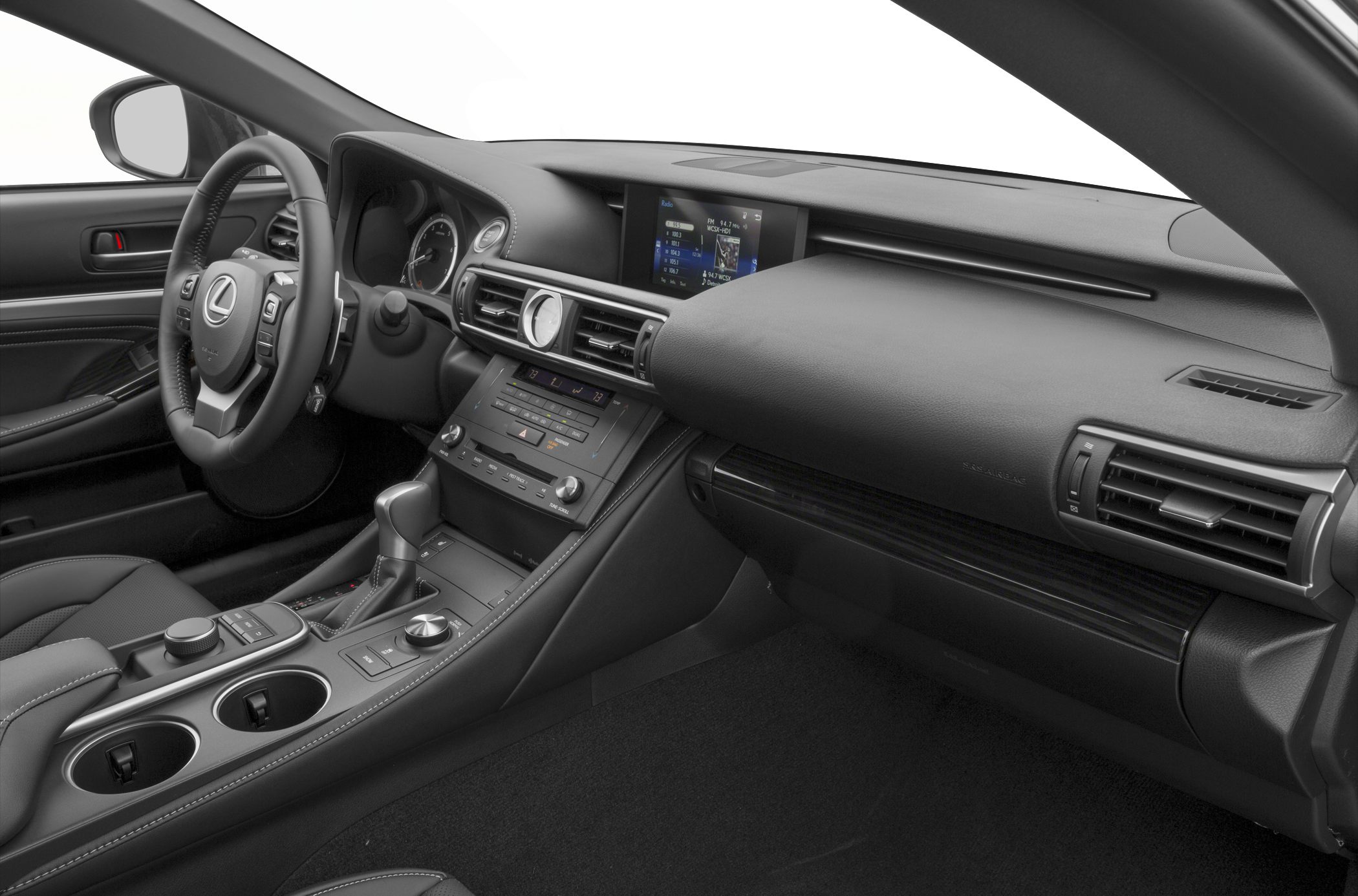 Dashboard, steering wheel, infotainment screen, and center console with controls