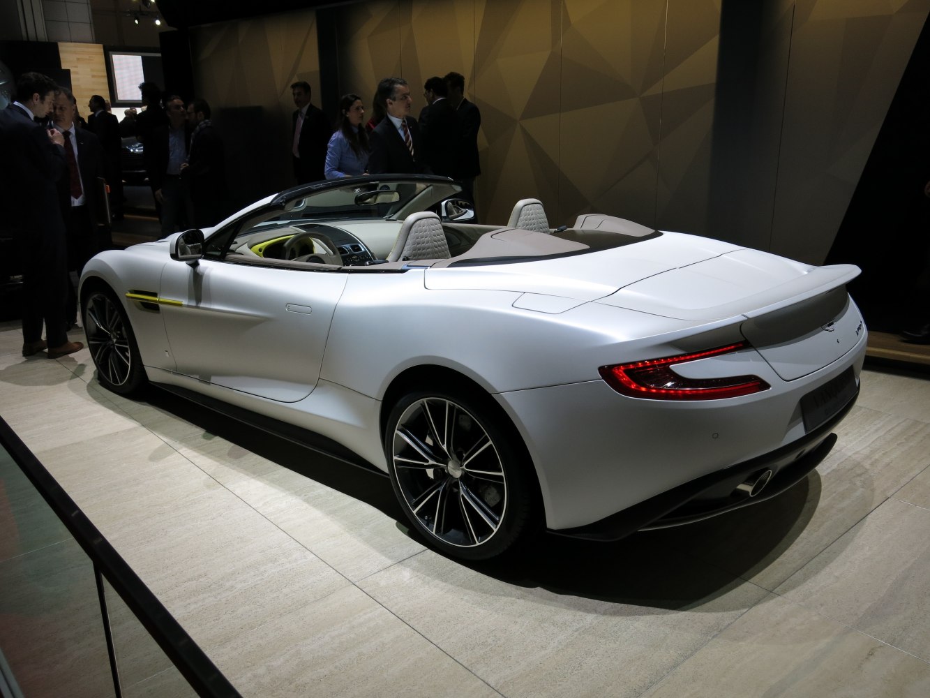 Rear side view of a sleek convertible with distinctive taillights and sporty wheels