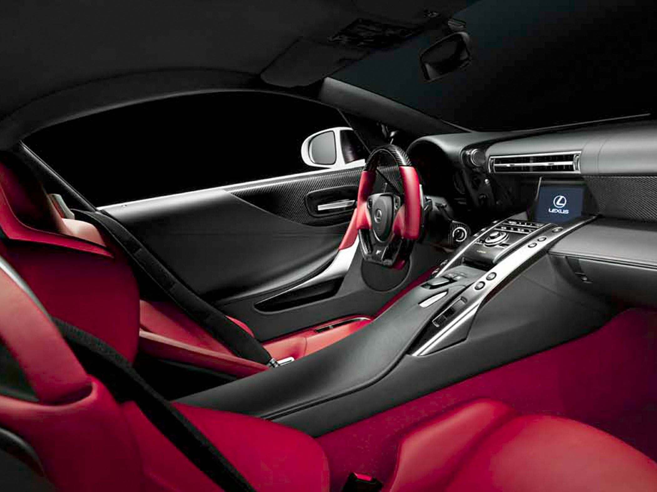 Luxury red leather seats with modern black dashboard and sporty steering wheel