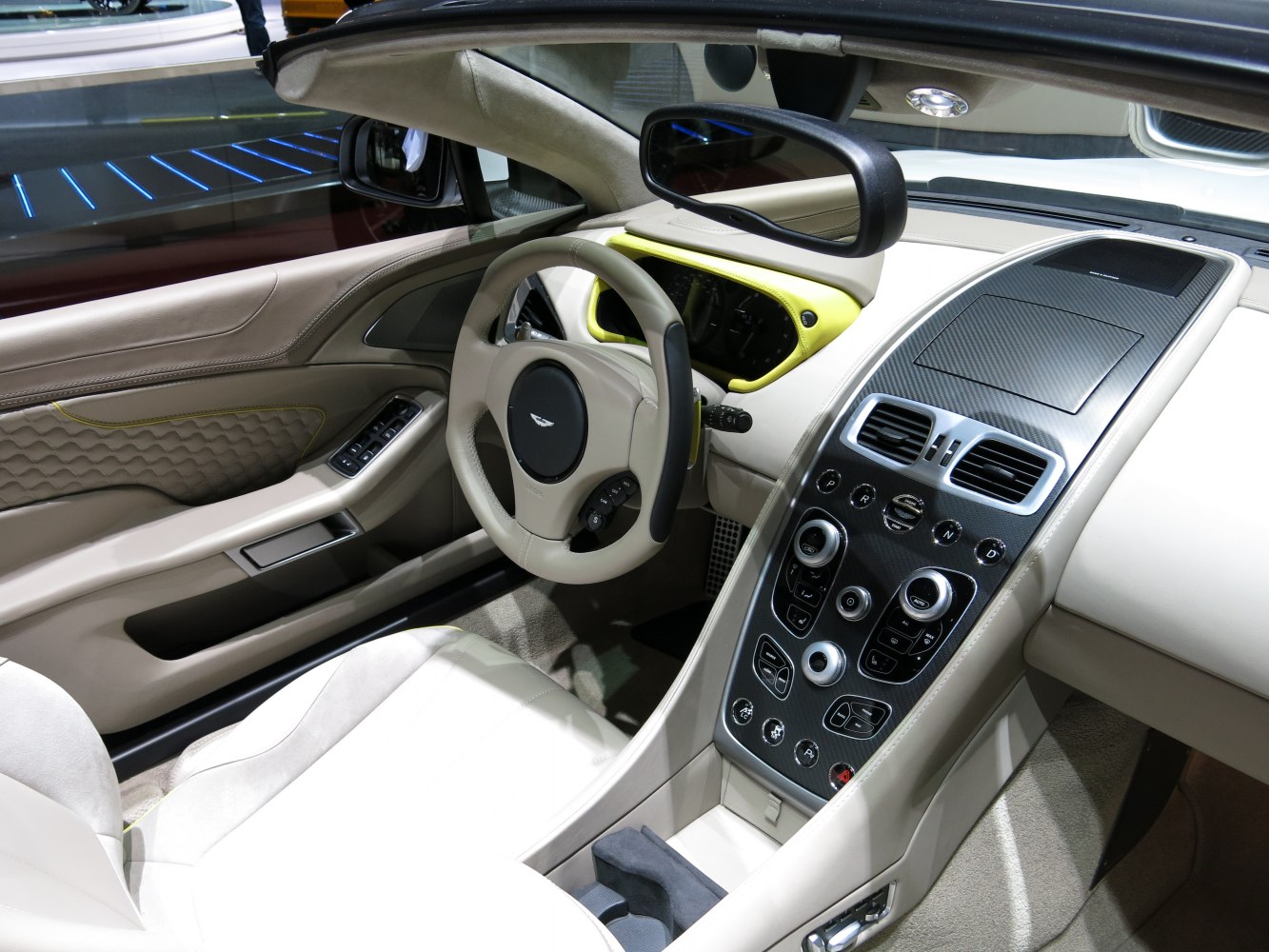 Sporty steering wheel and carbon fiber center console in beige luxury interior