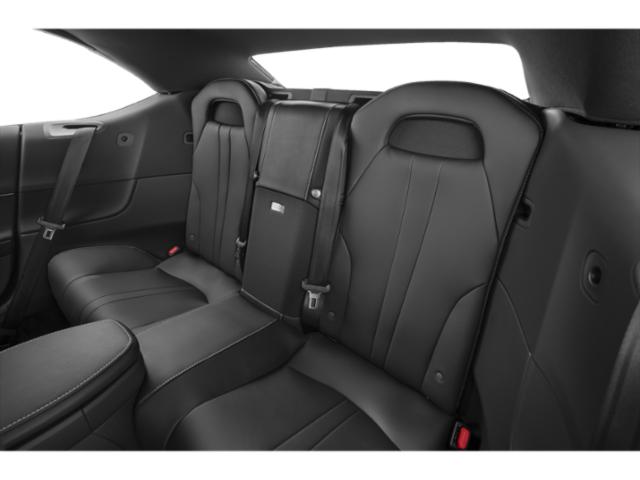 Rear black leather seating with premium stitching and fold-down armrest