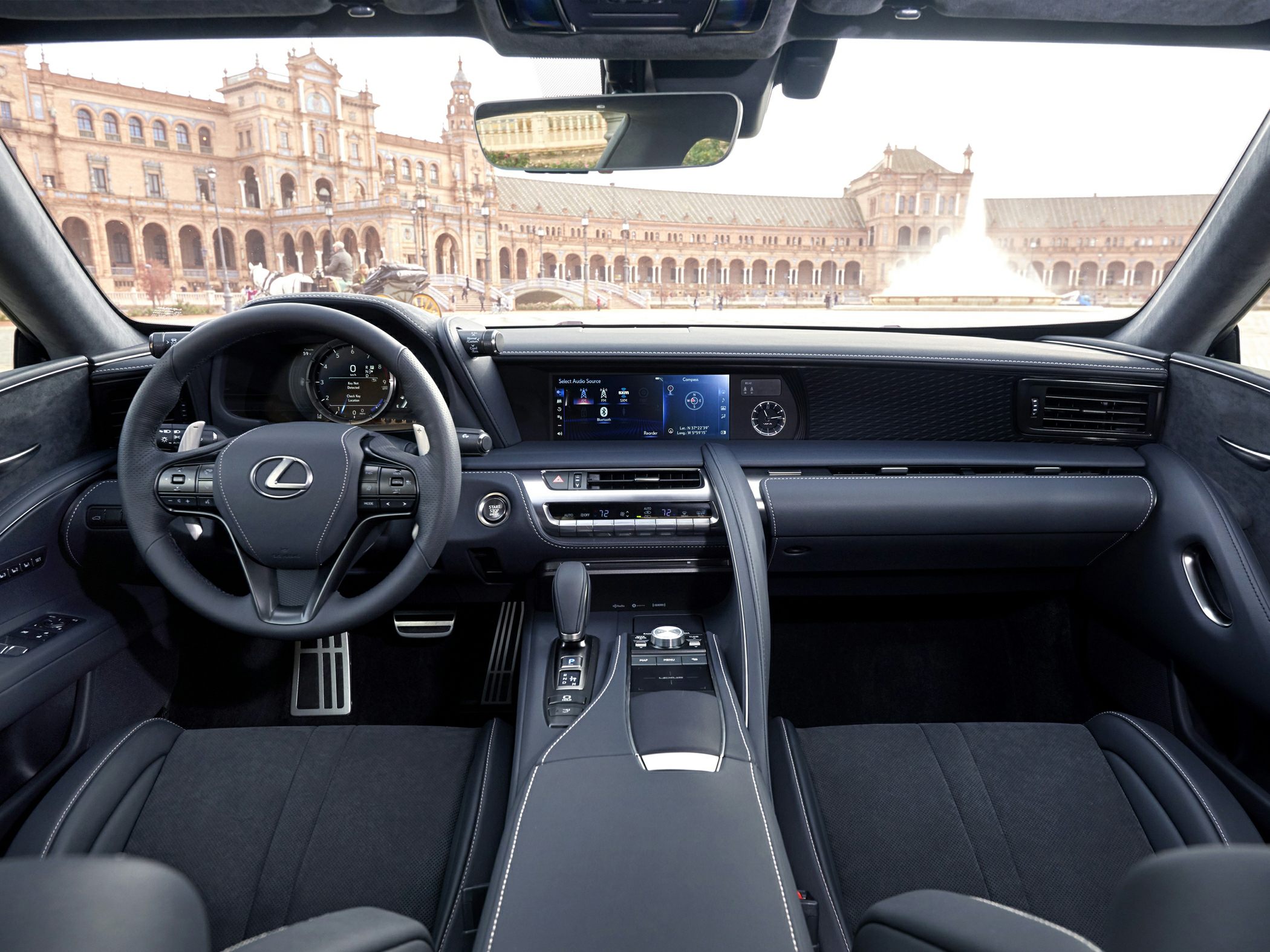 Steering wheel with Lexus logo and modern digital dashboard display