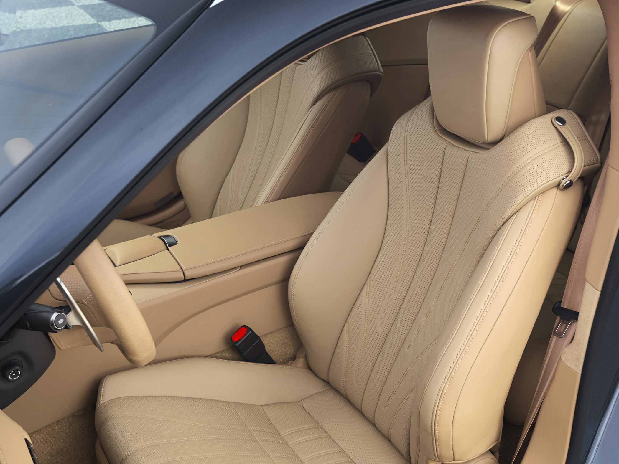 Beige leather seats with detailed stitching and ergonomic design