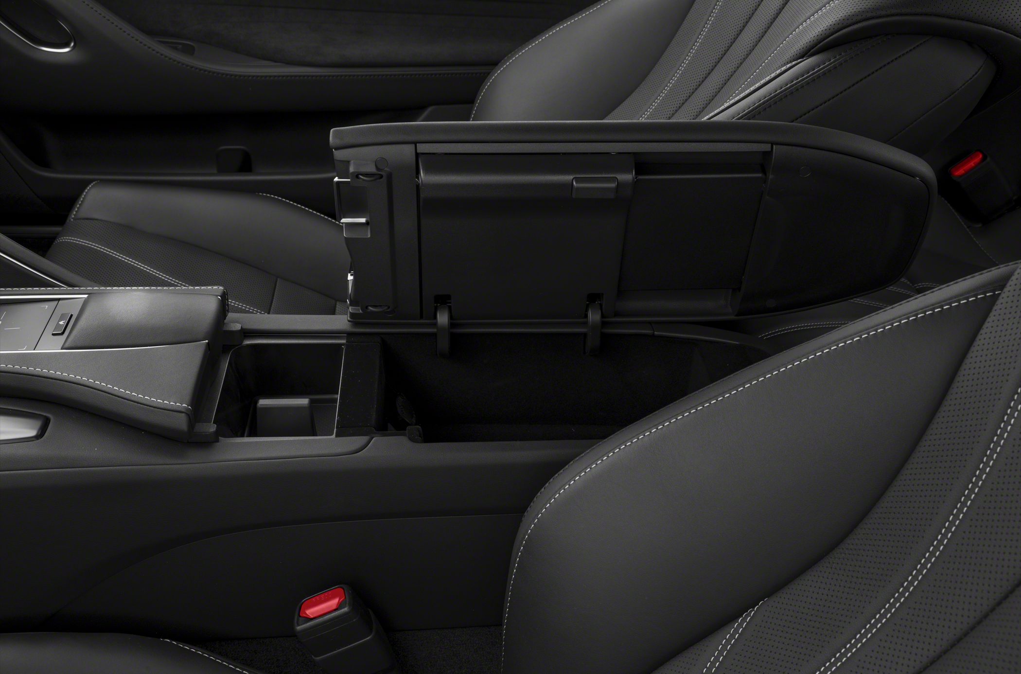 Open center console storage compartment with black leather and white stitching