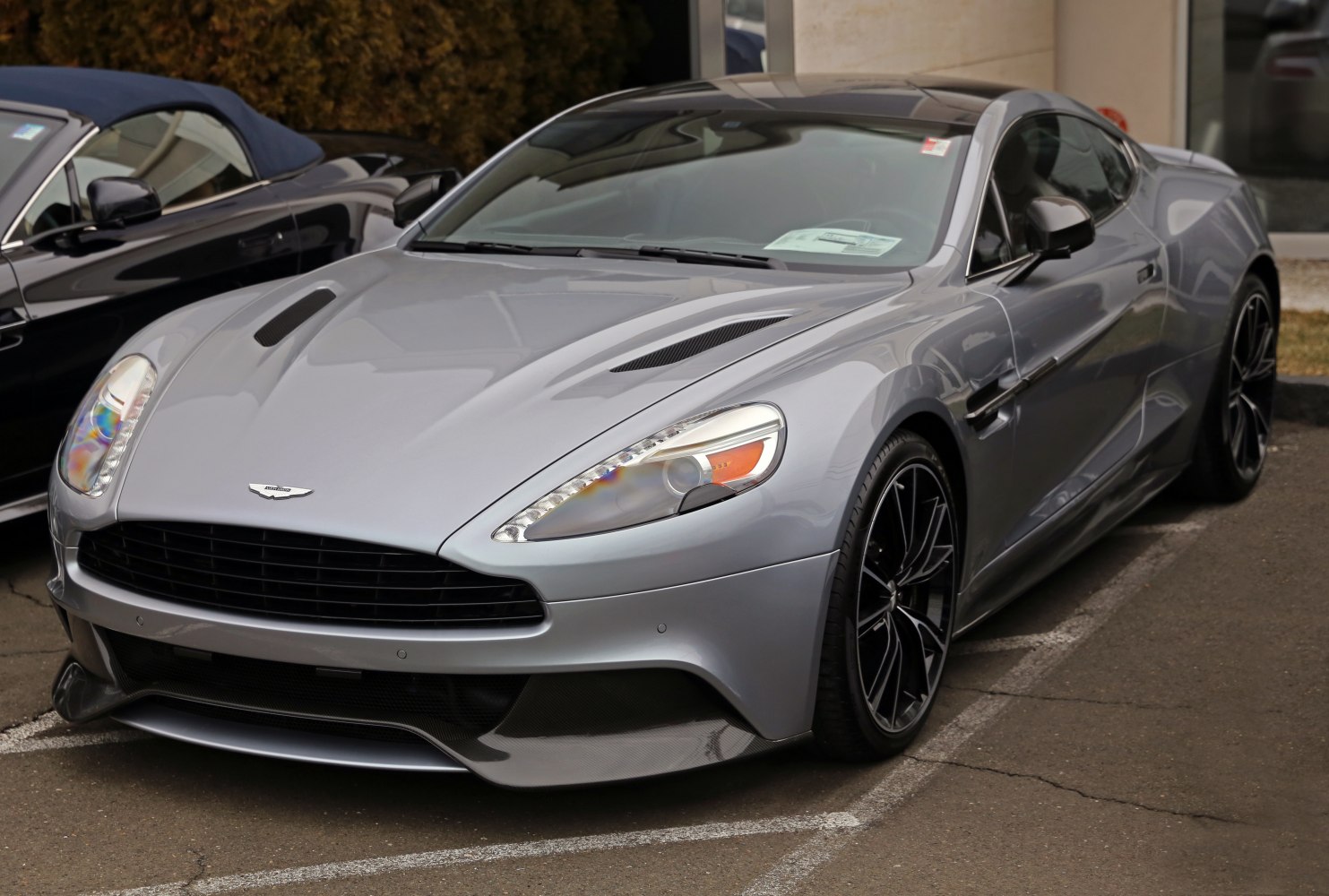 Front view of a sleek sports coupe with aerodynamic carbon fiber aero components.