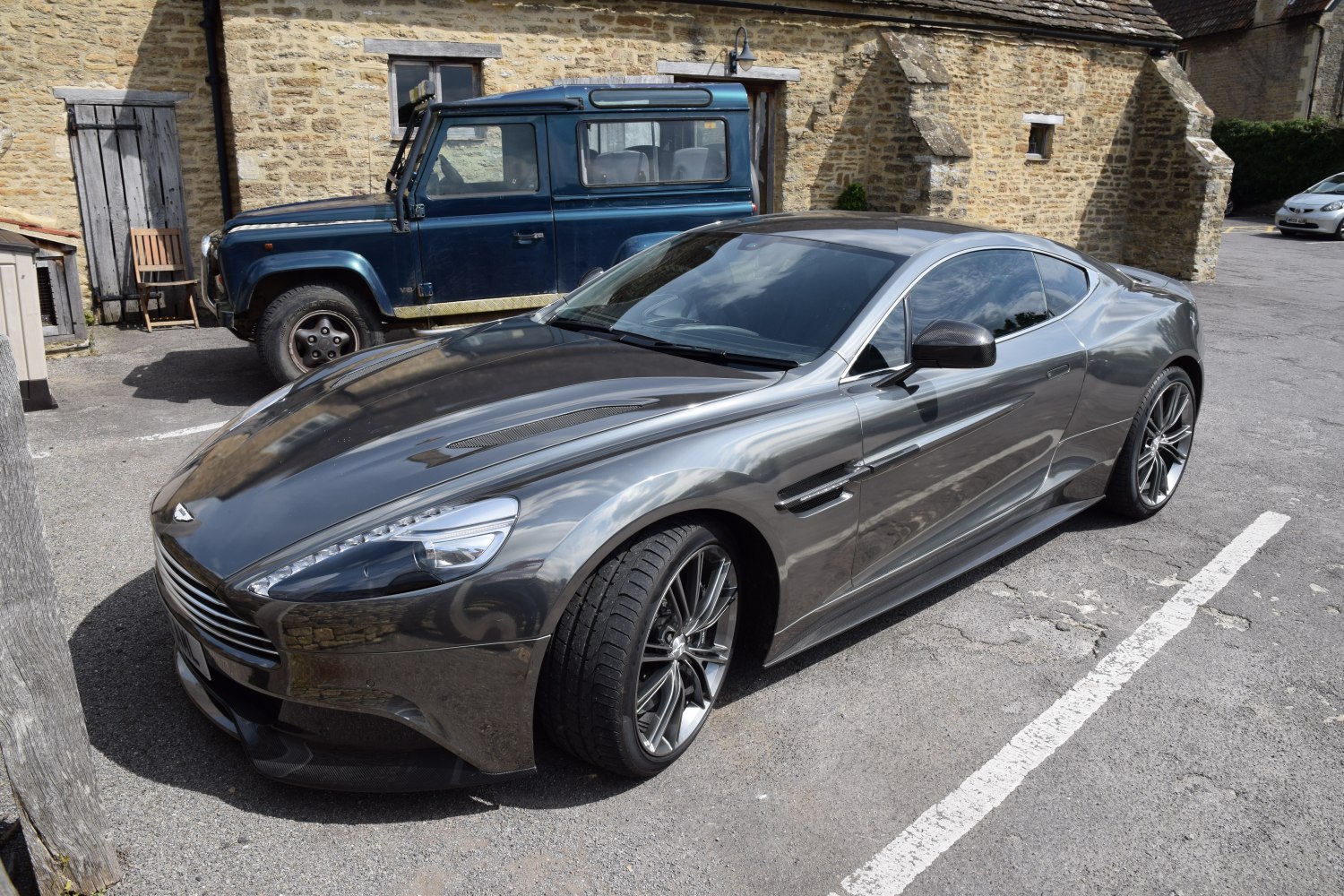 Sleek gray sports coupe with aerodynamic vents and multi-spoke wheels