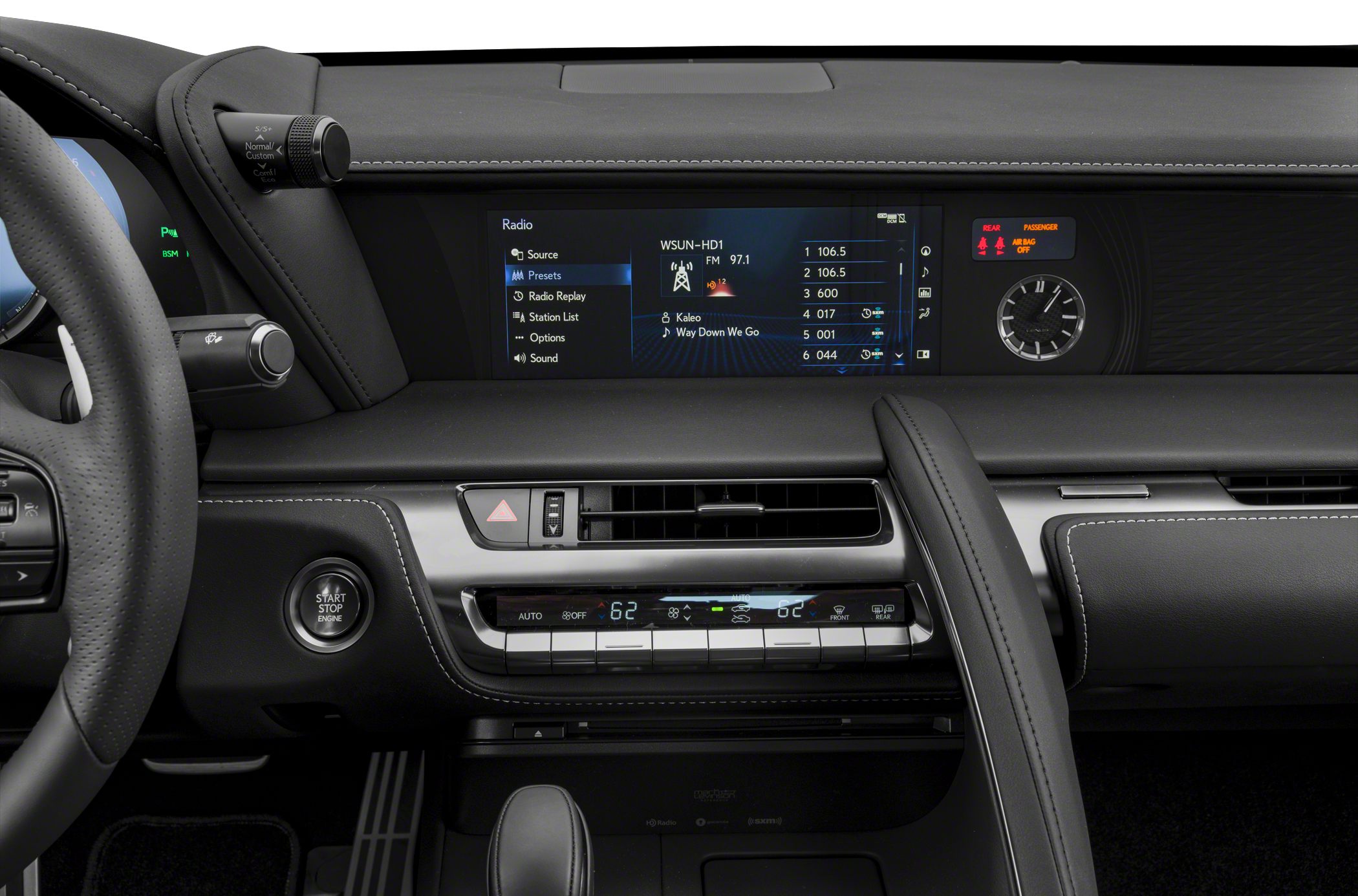 Dashboard with digital infotainment, analog clock, and climate controls